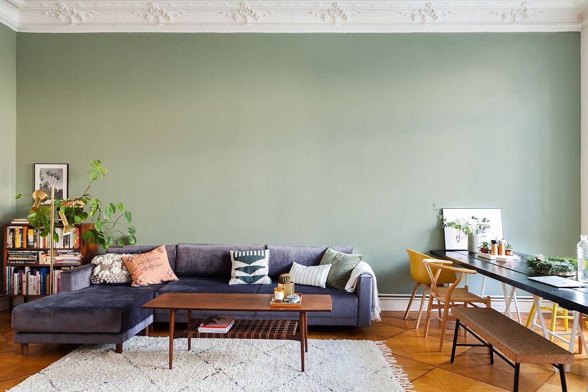 Darker shades of mint green in the living room create a relaxing backdrop for the bright blue sofa