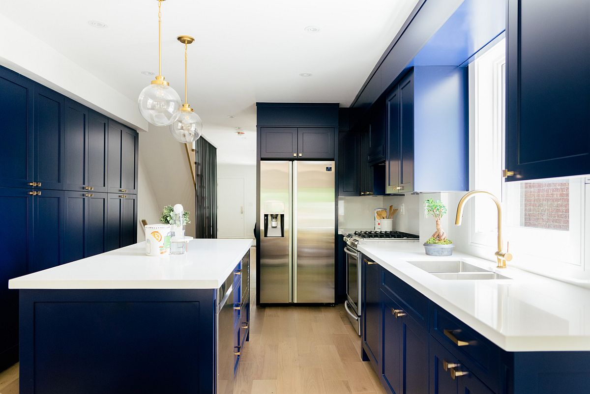 Dashing white and navy blue kitchen with brass handles and fixtures