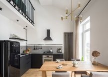 Double-height-dining-area-of-the-house-with-kitchen-in-black-next-to-it-49018-217x155