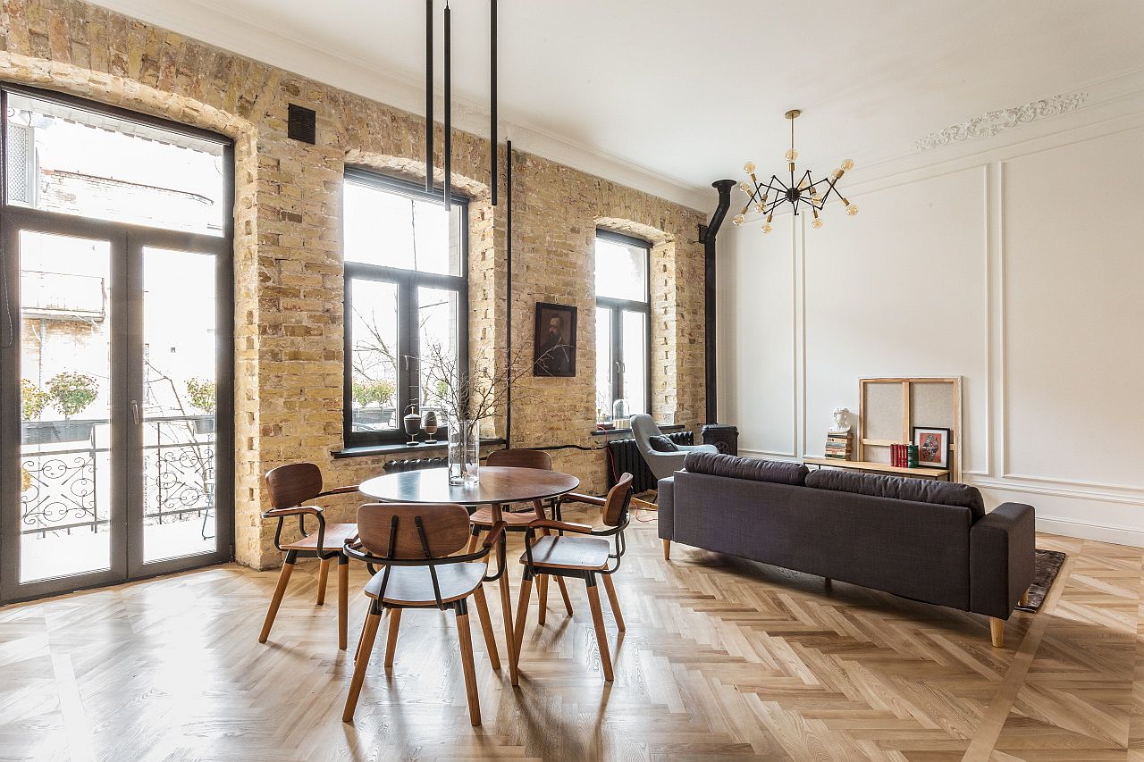 Exposed brick walls and arched window bring a sense of timeless charm to the modern apartment