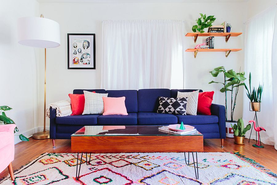 Eye-catching-navy-blue-sofa-colorful-rug-and-accent-pillows-bring-color-to-this-white-eclectic-living-room-78327