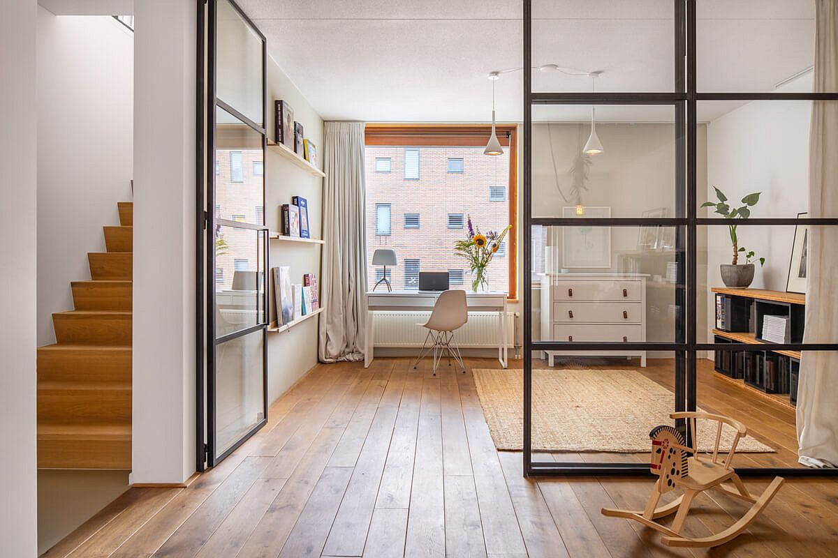 Framed glass wall delineate space without actually stoping the flow of light inside the Amsterdam home