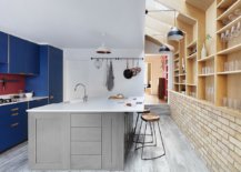 Gorgeous-blue-cabinets-add-color-and-contrast-to-the-neutral-kitchen-with-brick-walls-and-wooden-shelves-28108-217x155
