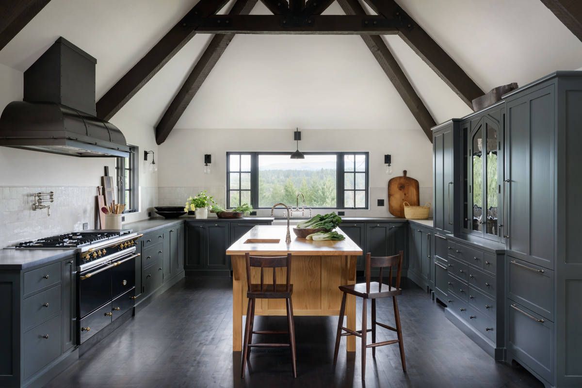 Gorgeous modern Mediterranean kitchen in black and white with floor that is dark and dashing