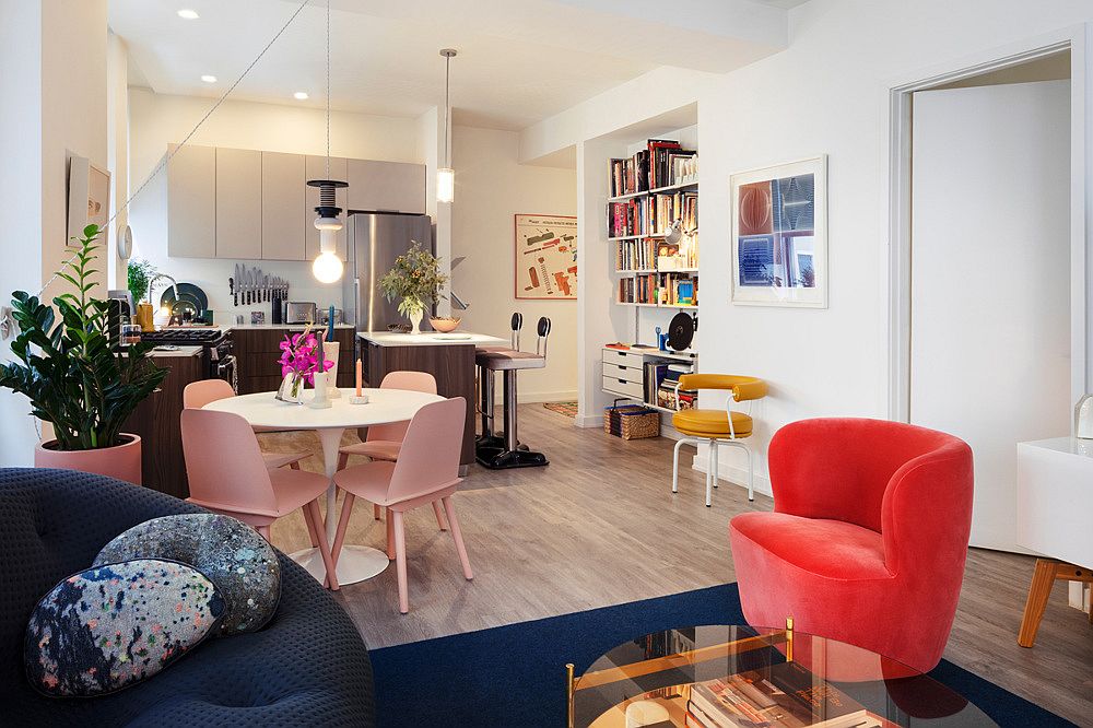 Gorgeous sofa in blue and chair in red add color to the modern living space