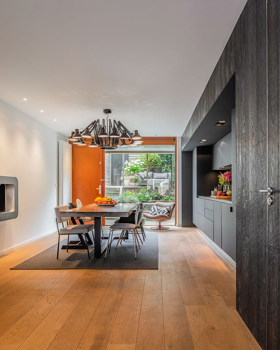 Gray single-wall kitchen along with dining area on the lower level of the house