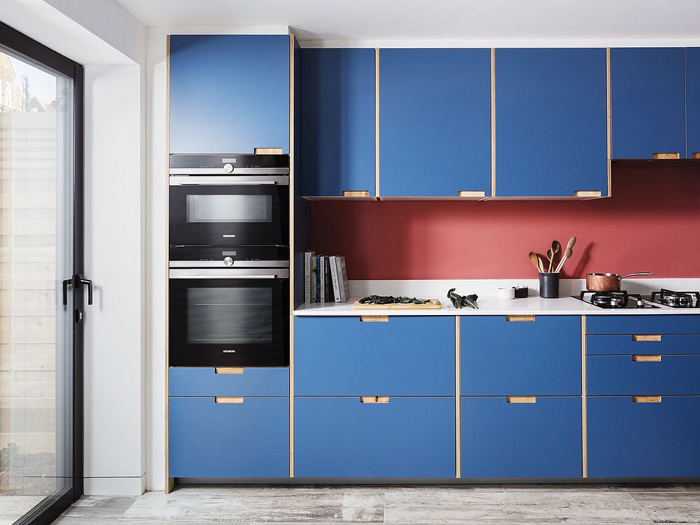 Ingenious pink backsplash also adds color to the kitchen that is already filled with blue