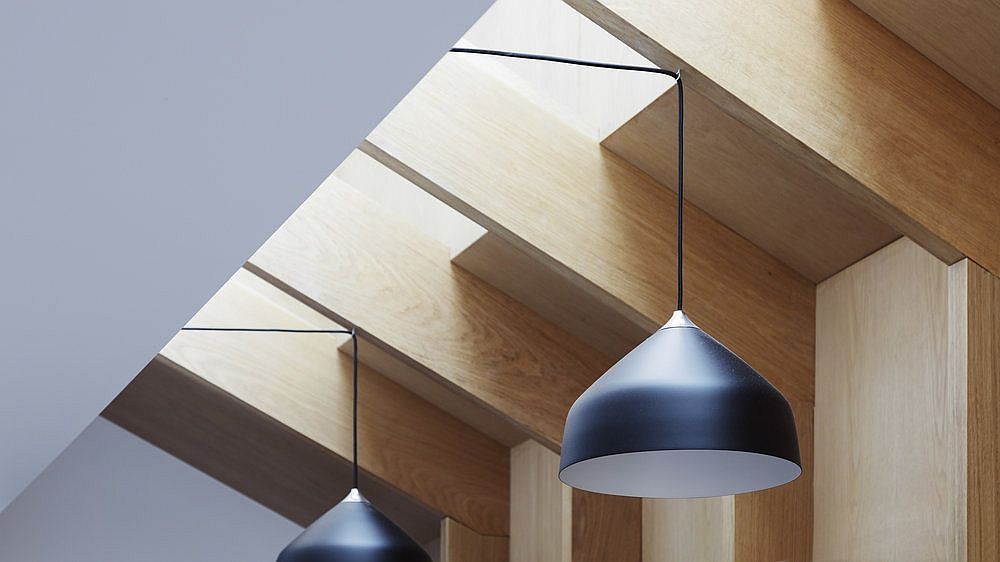 Innovative ceiling design and pendant lights bring ample ventilation into the house