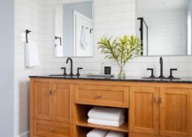 It-is-the-floor-that-brings-black-to-this-black-and-white-bathroom-with-a-lovely-wooden-vanity-17602-217x155