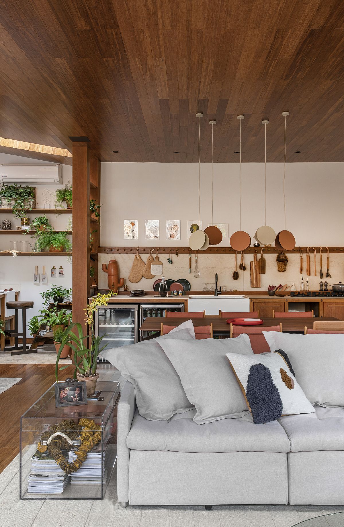 Kitchen of the family room in the backdrop uses hooks instead of usual floating shelves