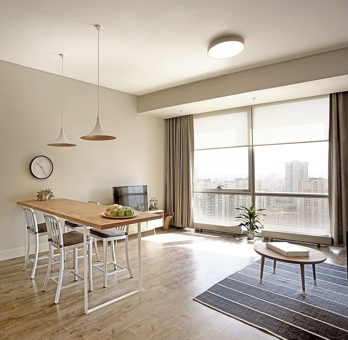 Large glass wall of the apartment in skyscraper brings light into the interior