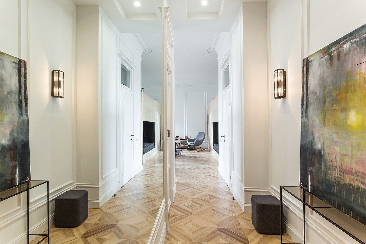 Large mirror and lovely art work welcome you at the entry of this beautiful Kiev apartment