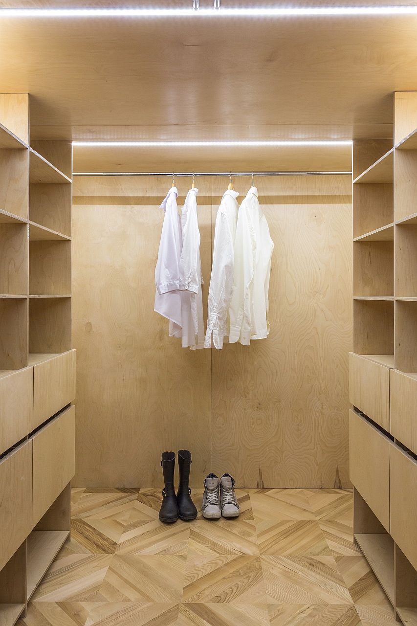 Lighting and wooden walls give the walk-in wardrobe a fabulous modern appeal