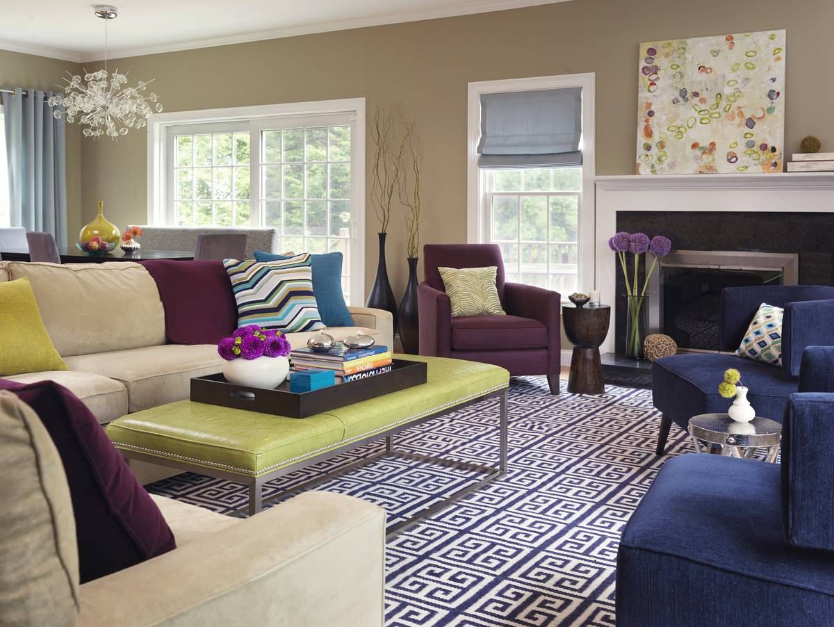 Living room with greige walls and colorful decor pieces feel charming and a touch eclectic at the same time