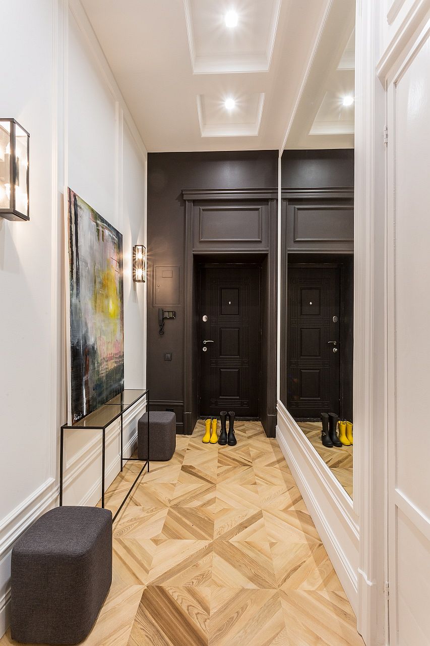 Mirror at the entry hallway gives the interior a more spacious and stylish look