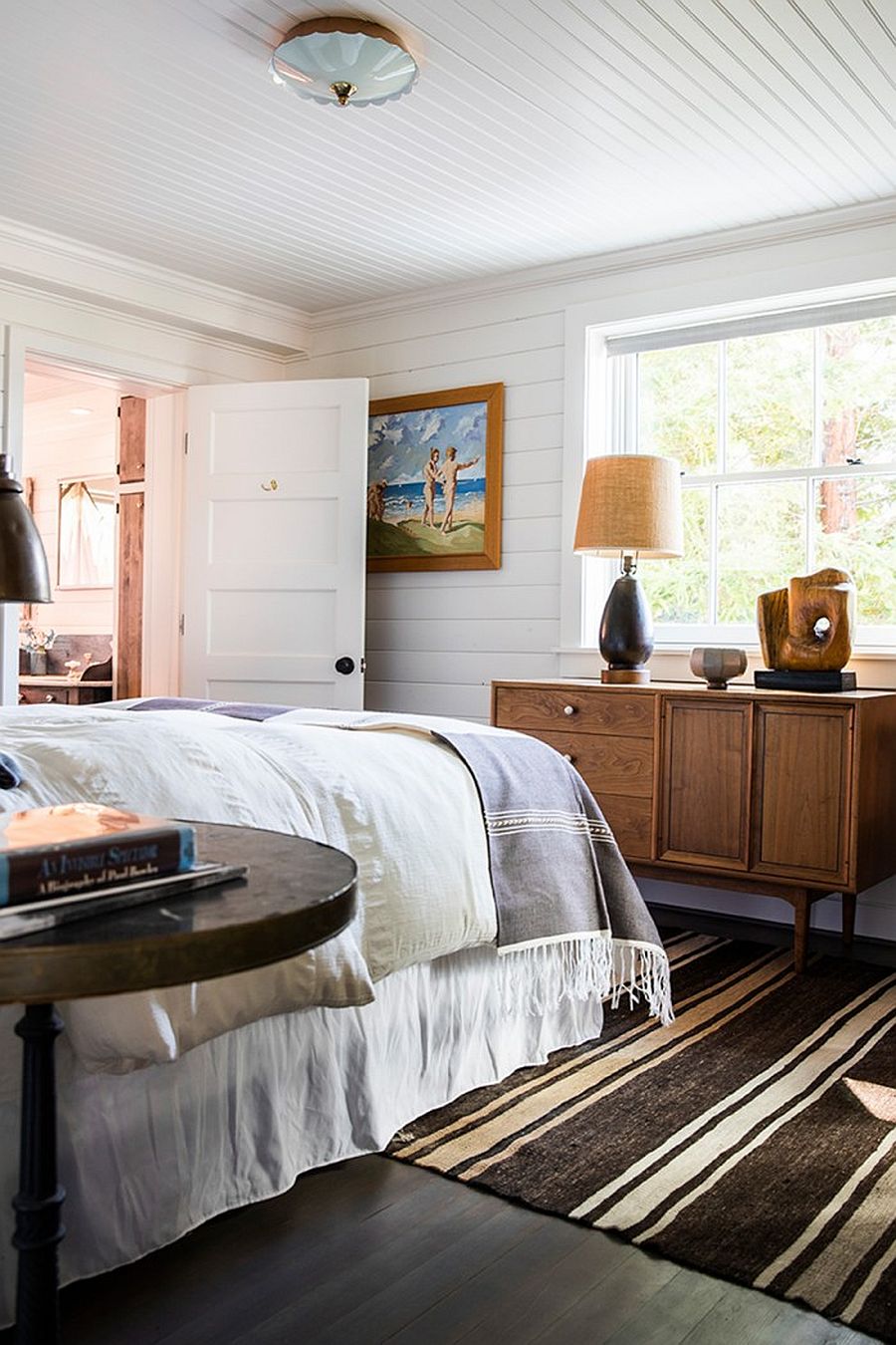 Modern coastal bedroom in white with charming decor that takes you back in time