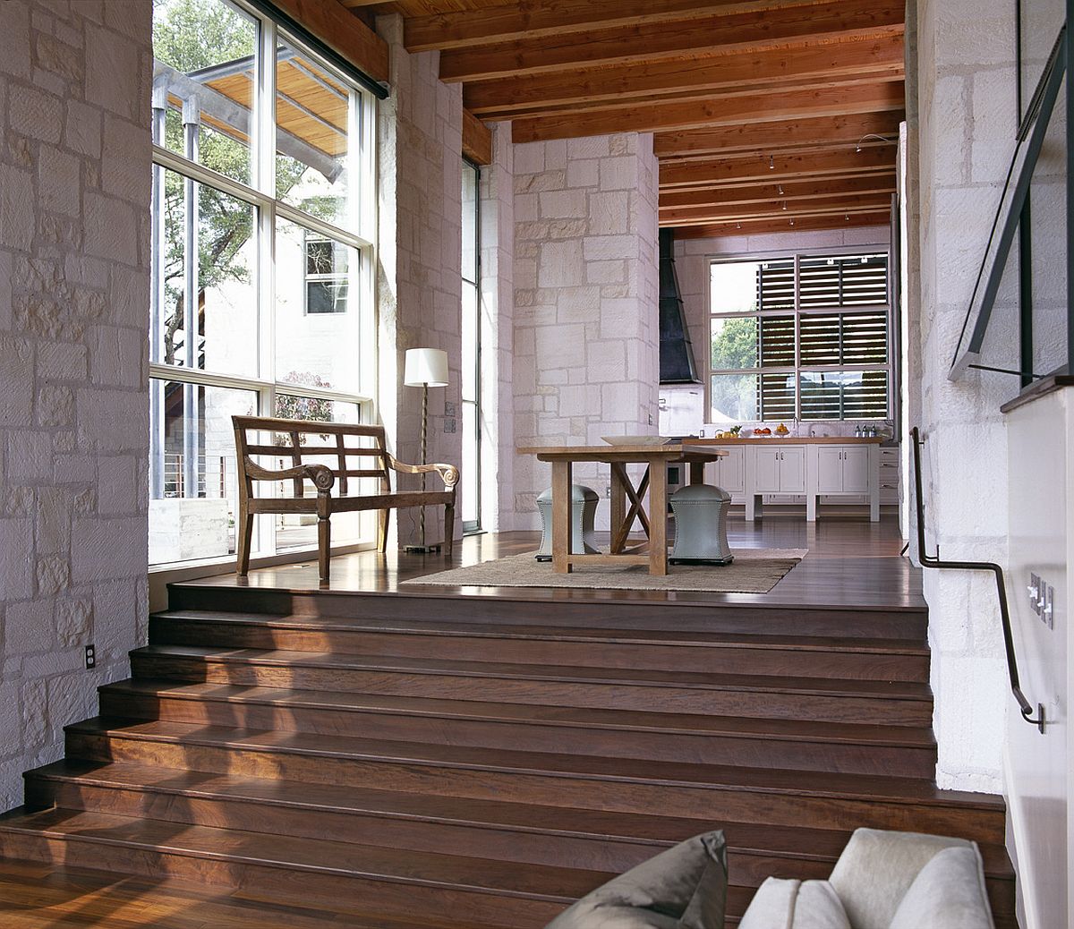 Modern-farmhouse-dining-area-of-the-house-with-stone-walls-and-large-glass-windows-19315