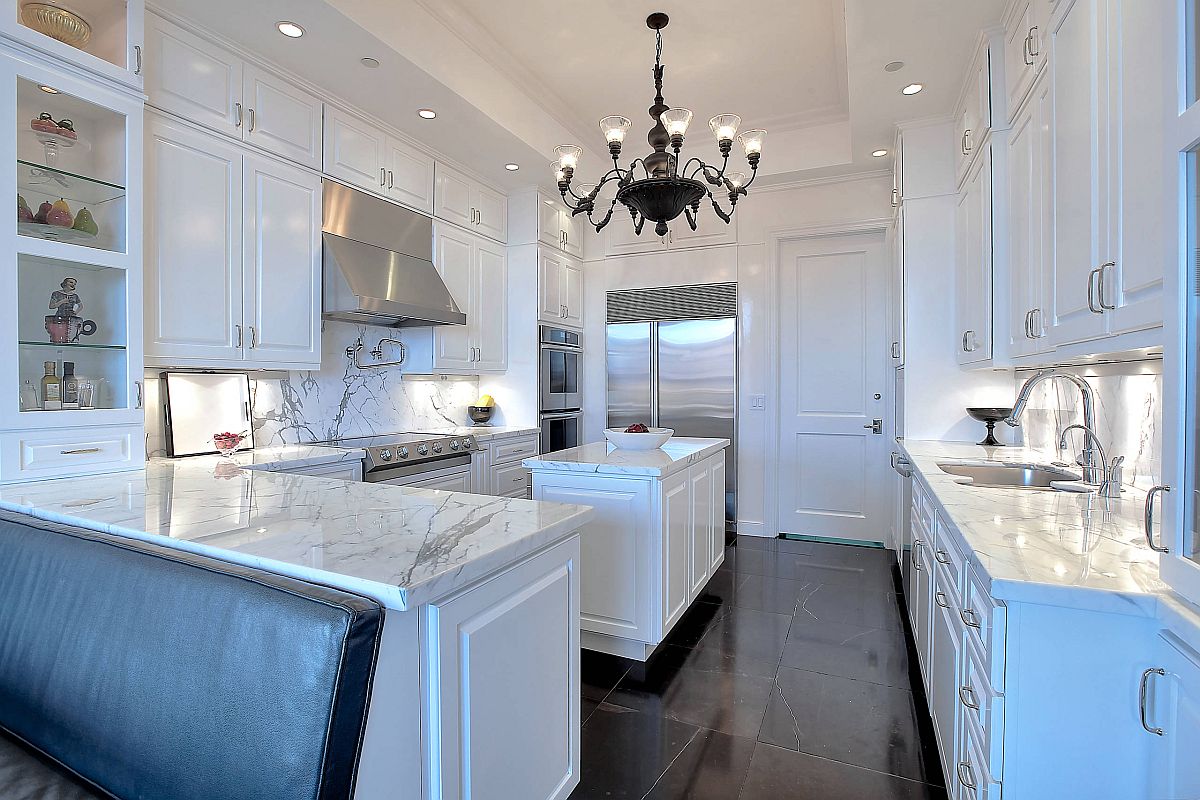 Modern transitional kitchen in white with glossy black floor and lovely lighting