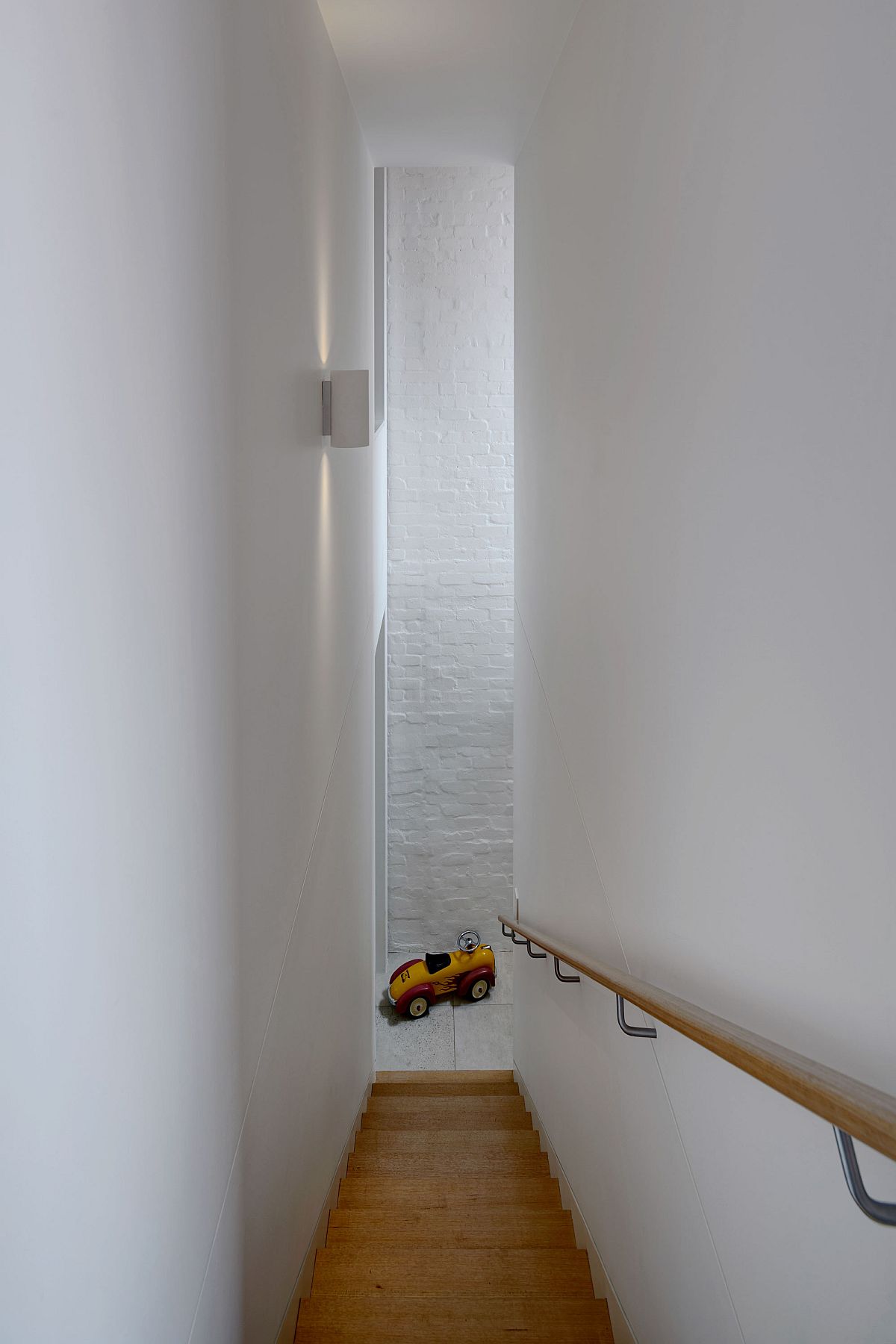 Narrow staircase leading to the top level of the house