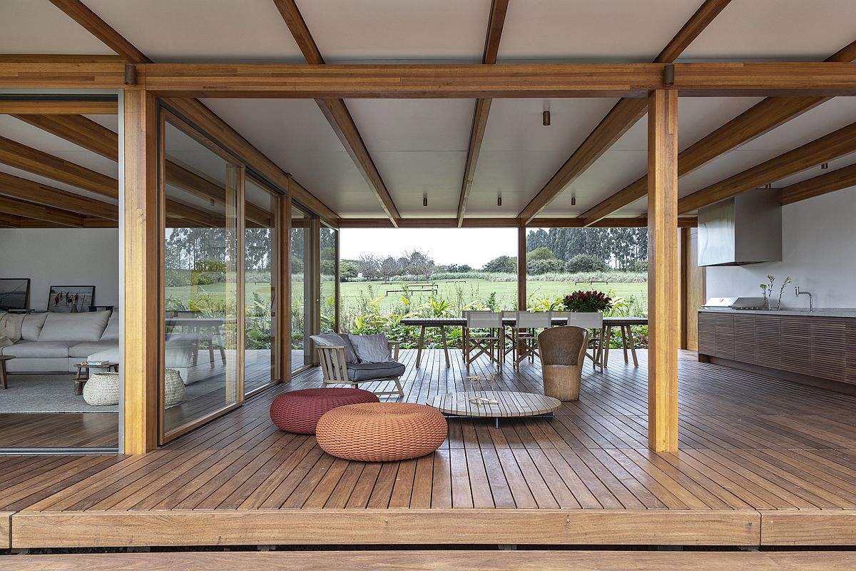 Open kitchen and dining area of the house is connected with the landscape on both sides