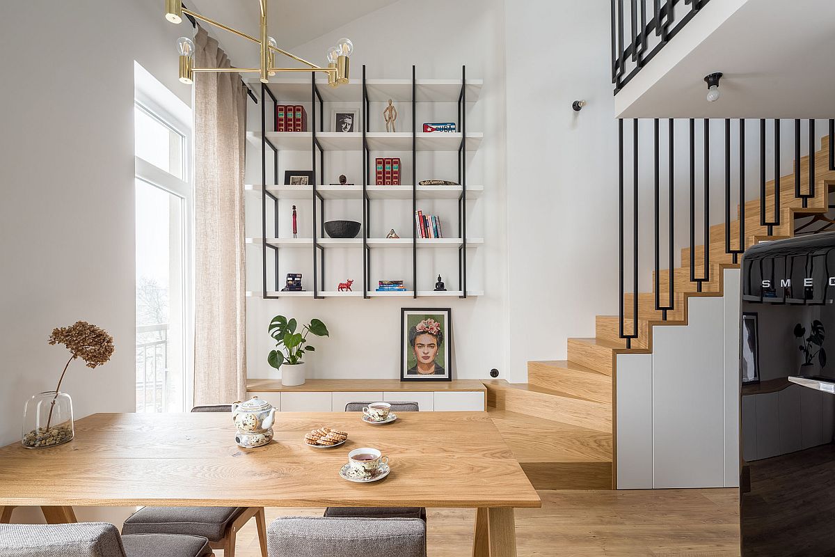 Open lower level of the small 52 sqm apartment in Lodz, Poland with a white and wood color cheme