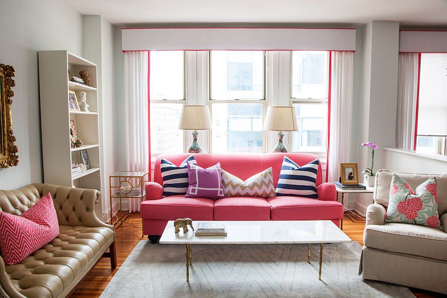 Pastel pink brings feminine charm to this curated modern eclectic living room in white