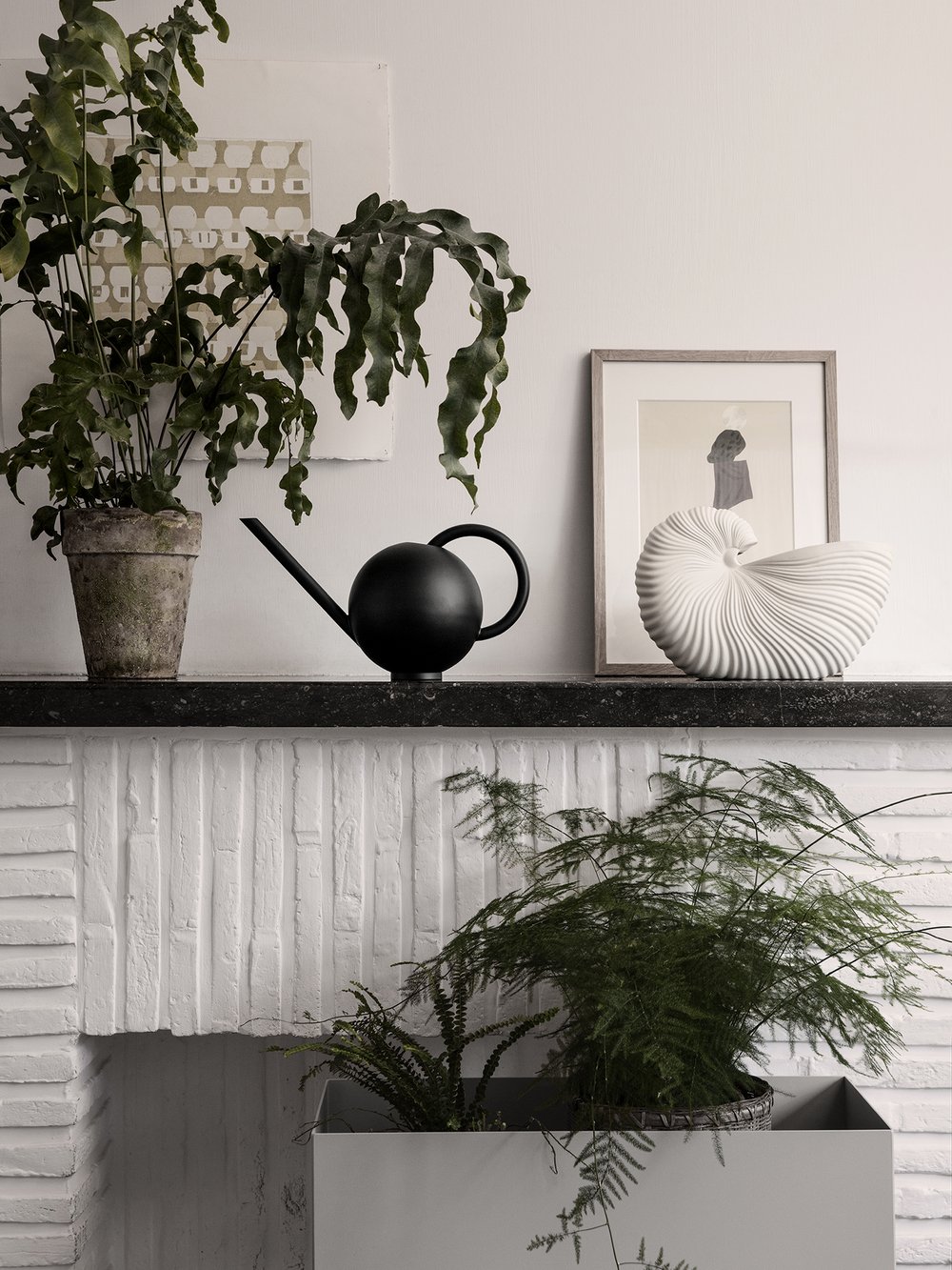 Plants adorn a vignette featuring decor from ferm LIVING