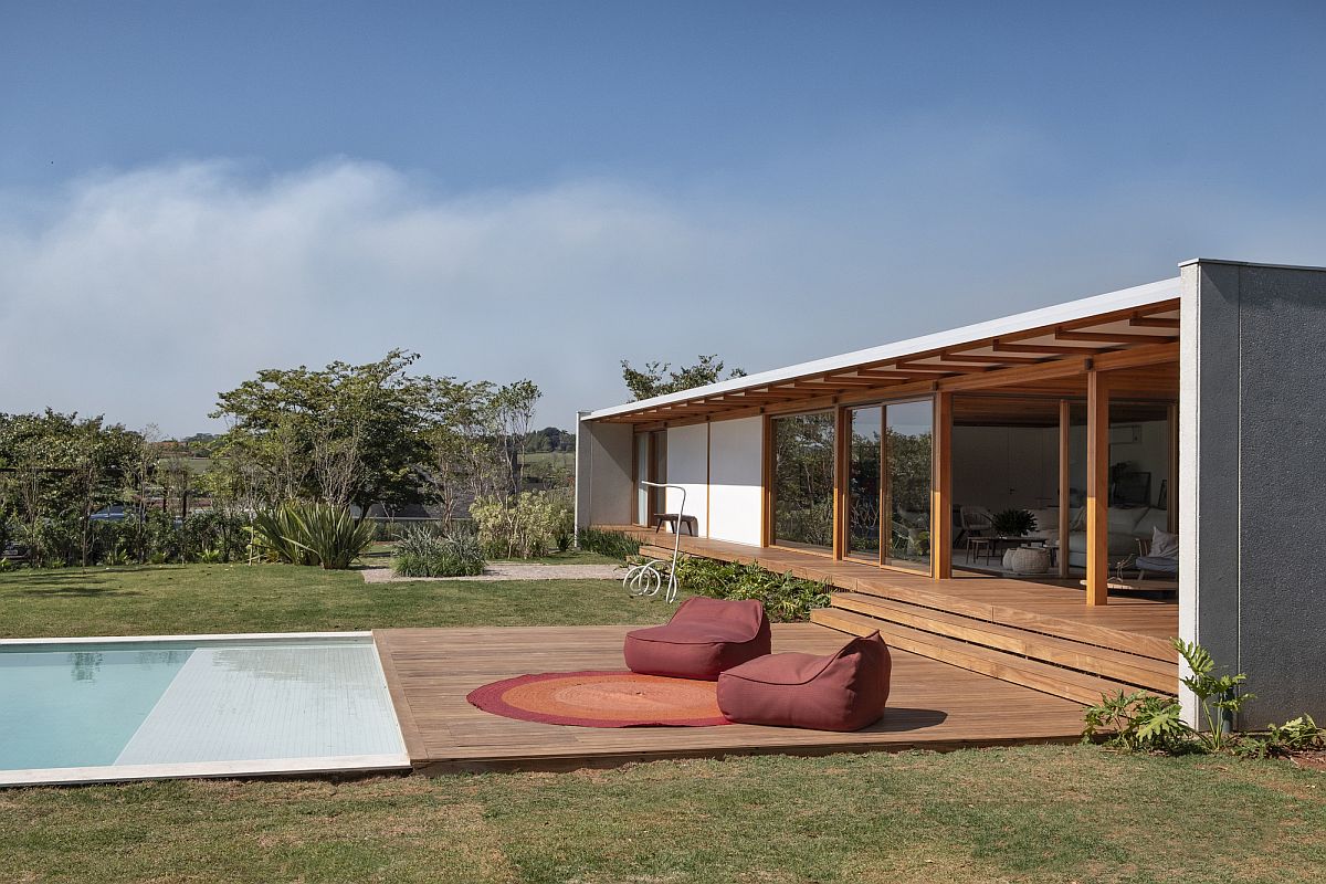 Poolside seats give the homeowners an opportunity to relax and take in the sunshine