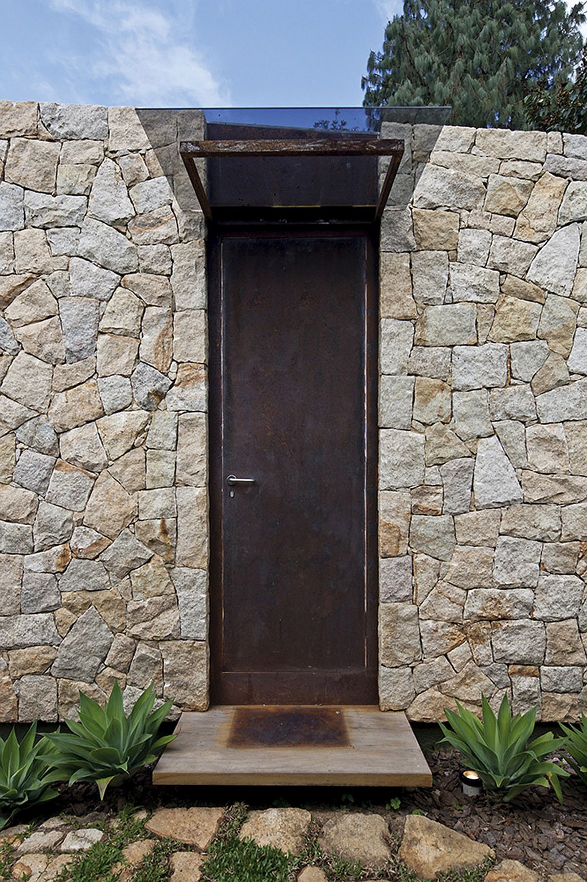 Protected entry to the writer's escape promises solitude and ample greenery behind it