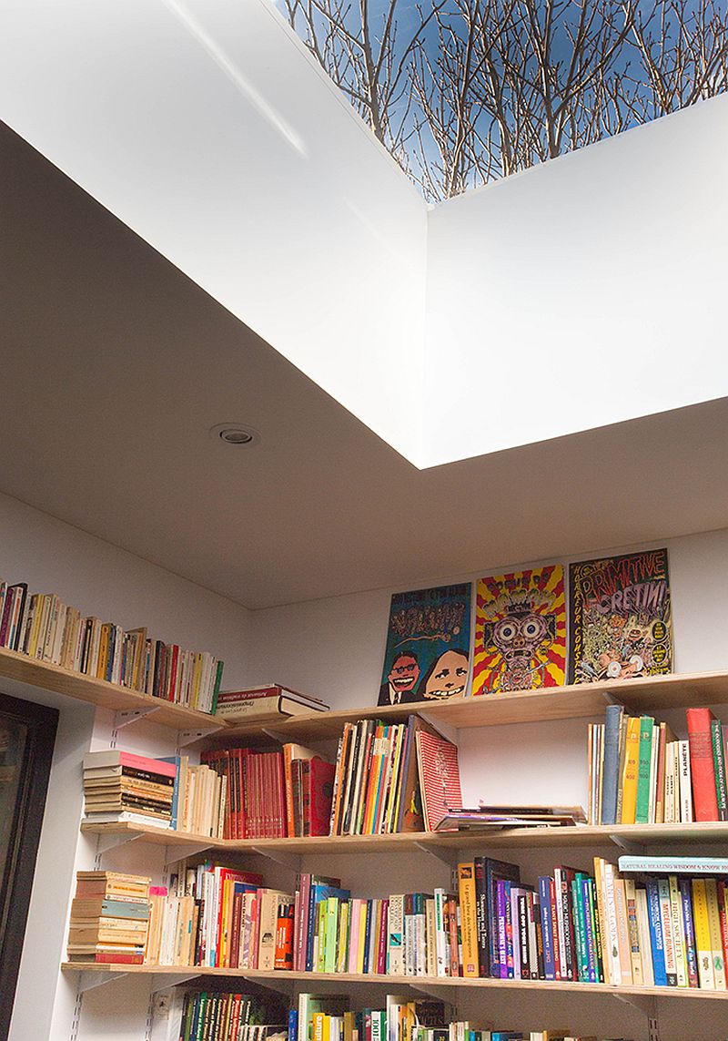 Reading lounge on the mezzanine level of the house with skylight feels both spacious and cheerful