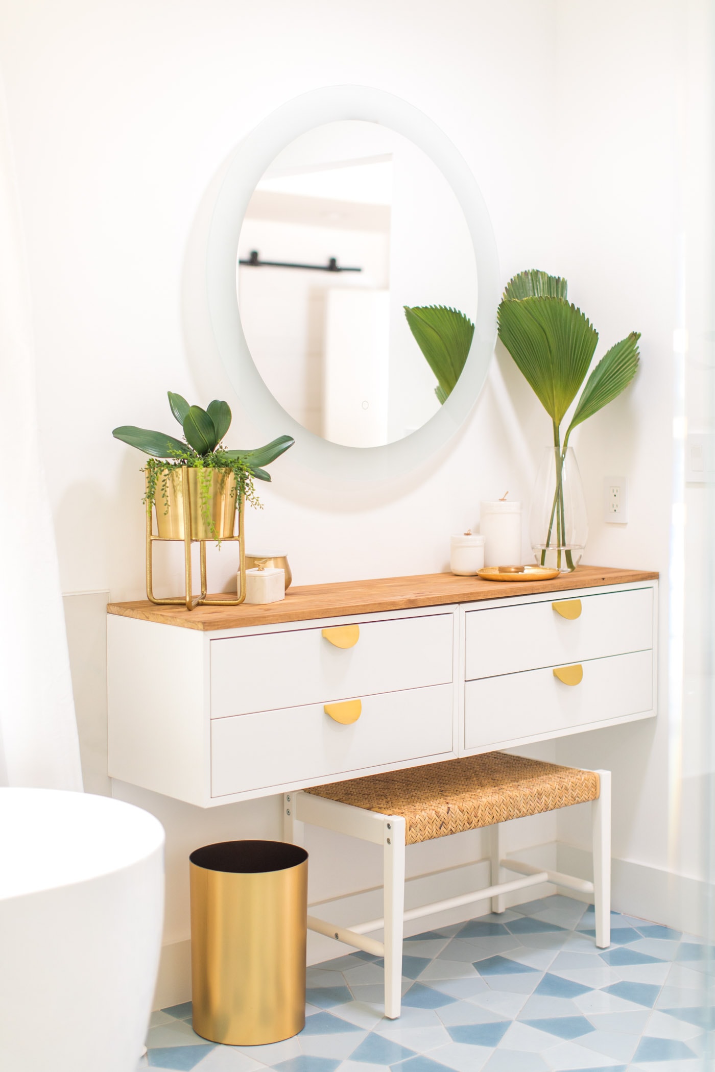 Round LED mirror in a bathroom renovation by Sugar & Cloth