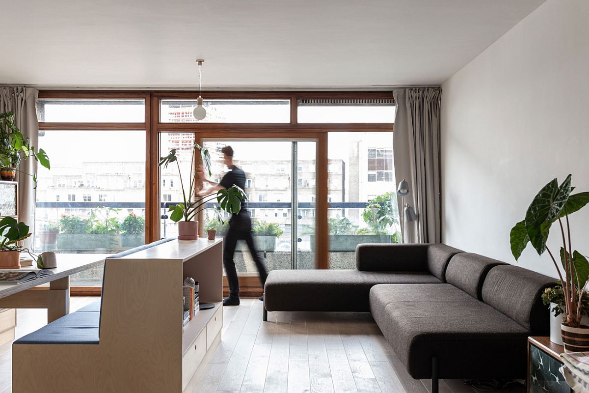 Sliding glass doors bring ample natural light into the small London studio apartment