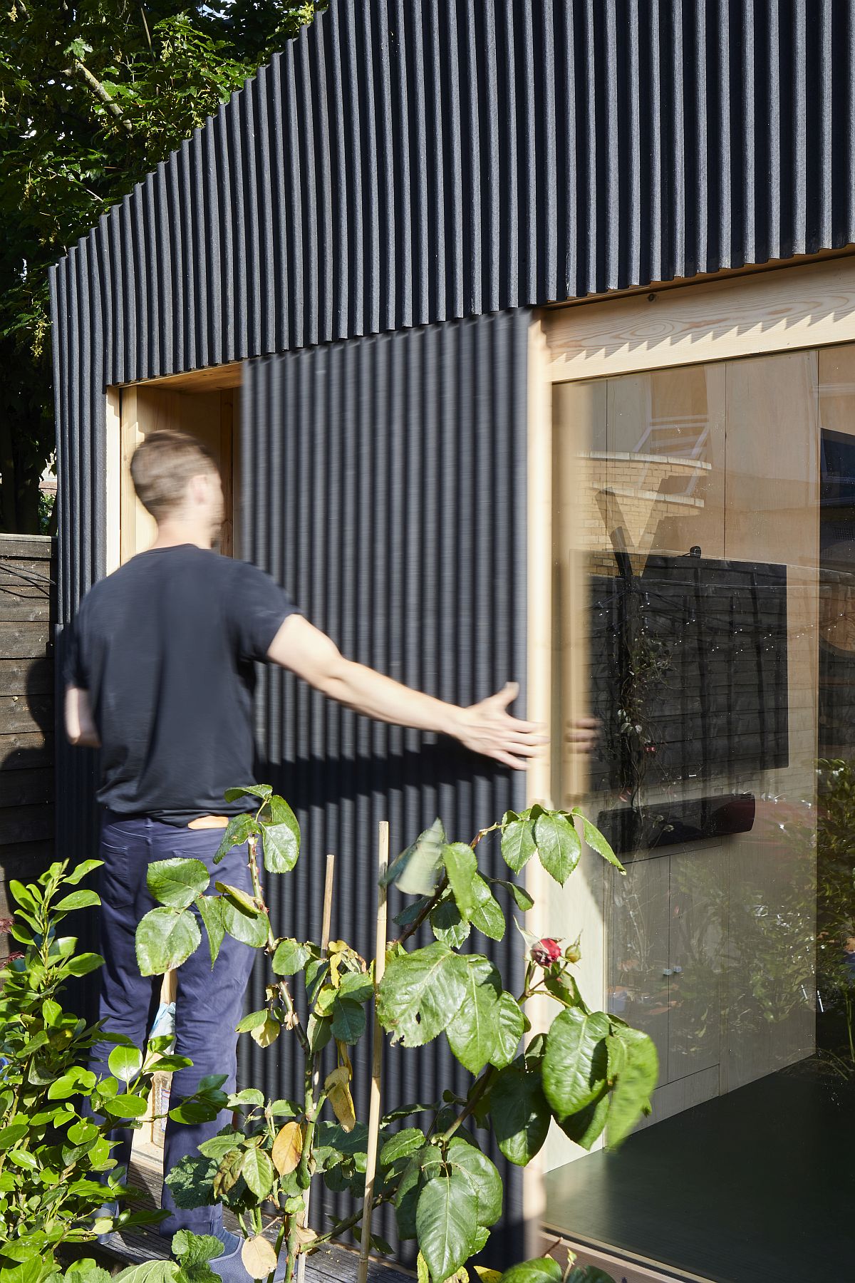 Sliding glass doors with timber frame connect the interior with the outdoors