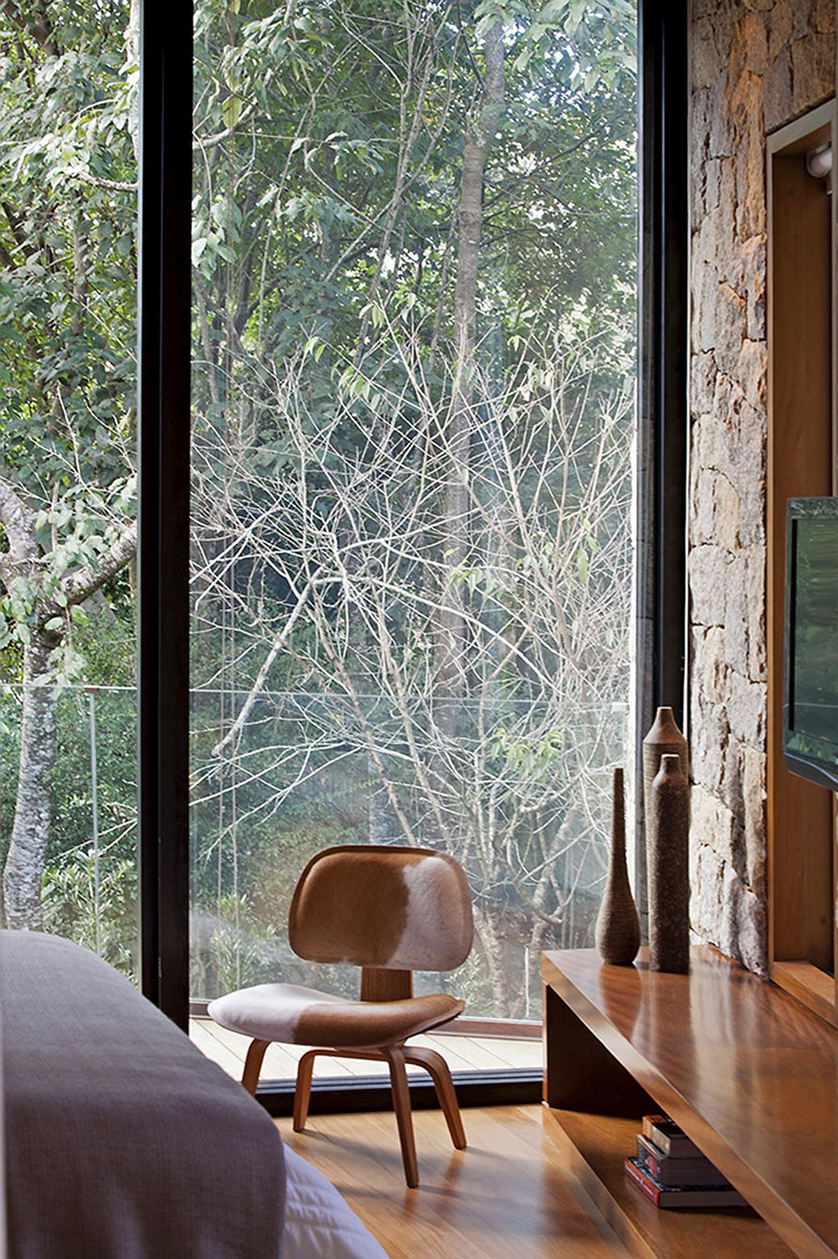 Sliding glass walls bring nature into the bedroom with ease