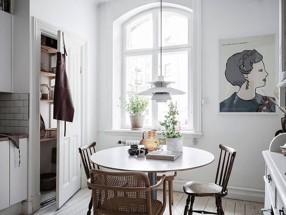 Small Scandinavian style dining area within the kitchen in white saves space in more ways than one