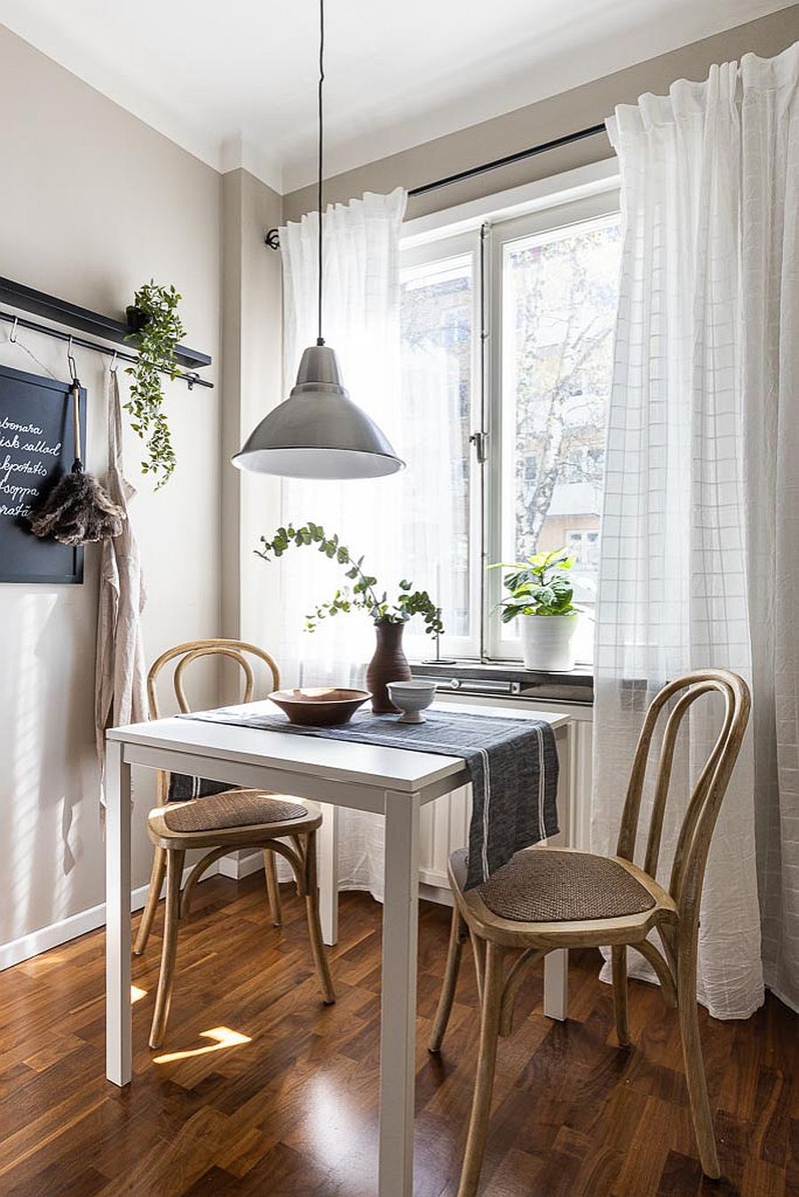 Small-dining-table-in-white-next-to-the-window-offers-a-cool-dining-area-50473