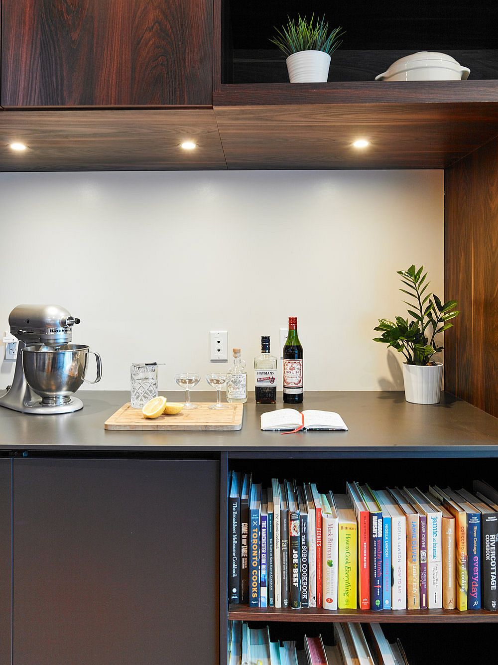 Small tea station in the kitchen with bookshelf underneath