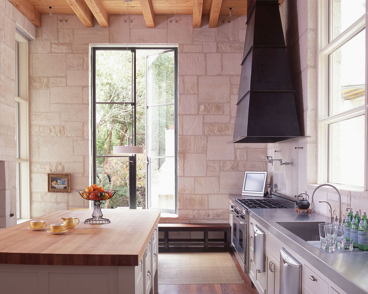 Stone along with wooden countertops gives this modern kitchen a traditional appeal