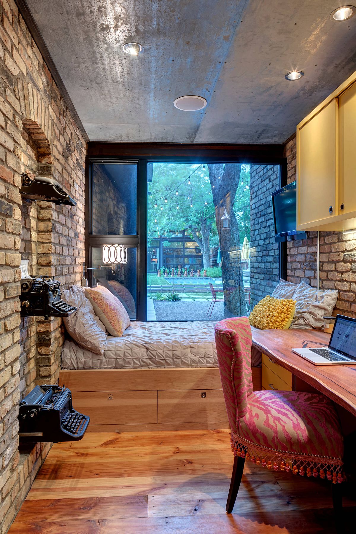 Storage space under the bed in the small bedroom gives it a more space-conscious design