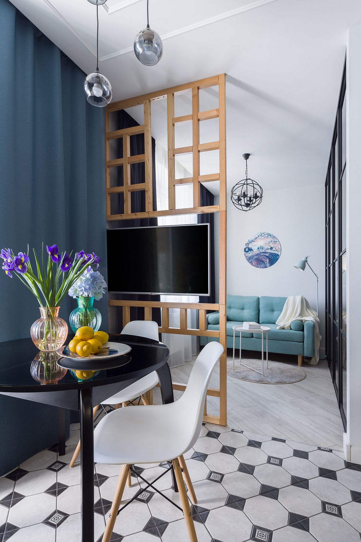 Tiny dining area in the small apartment with black dining table and a couple of chairs