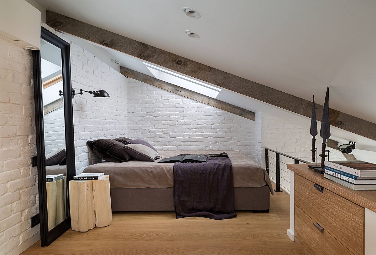 Ultra-small atic bedroom with sloped ceiling and large mirror that gives it a more spacious look