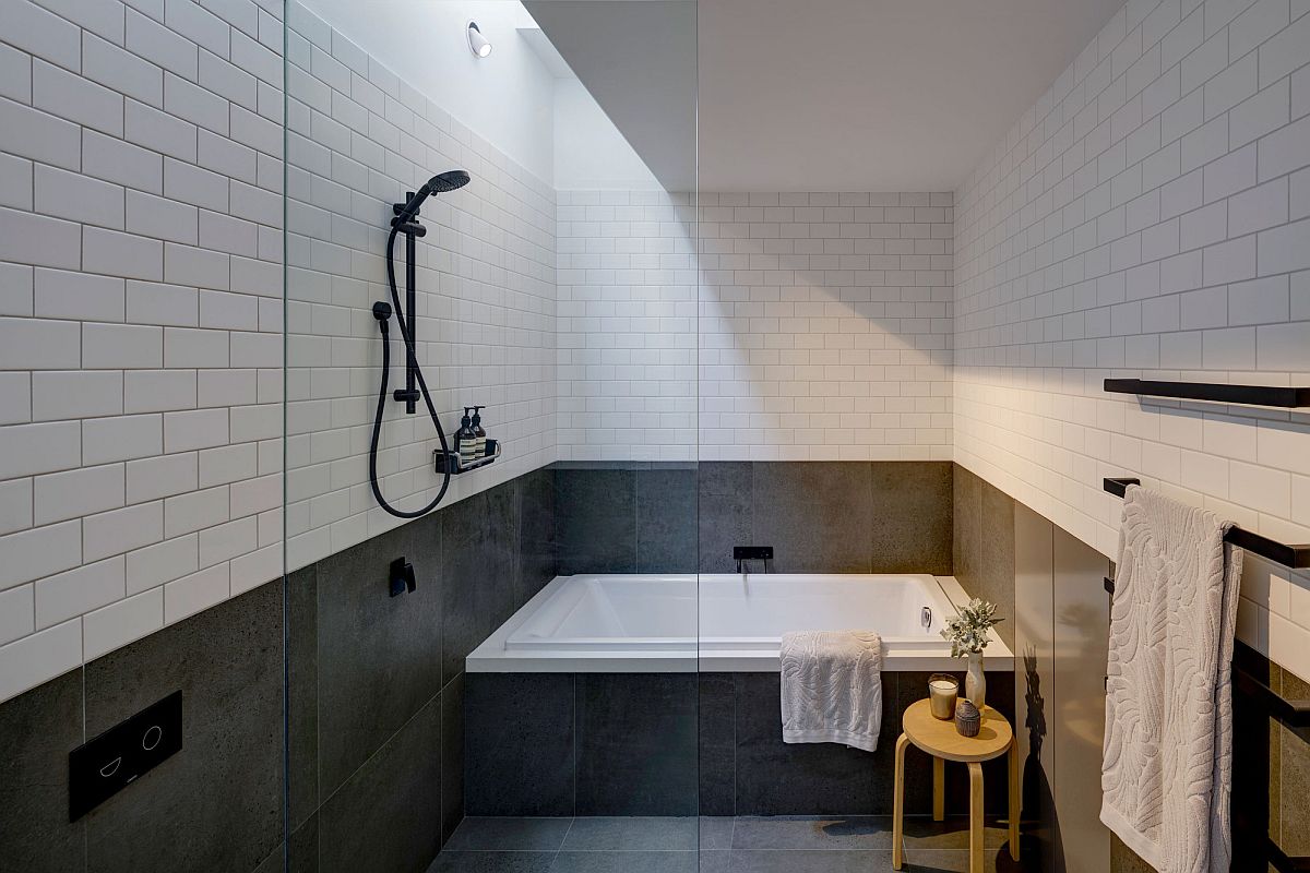 Upper level master bathroom in black and white with ample natural light