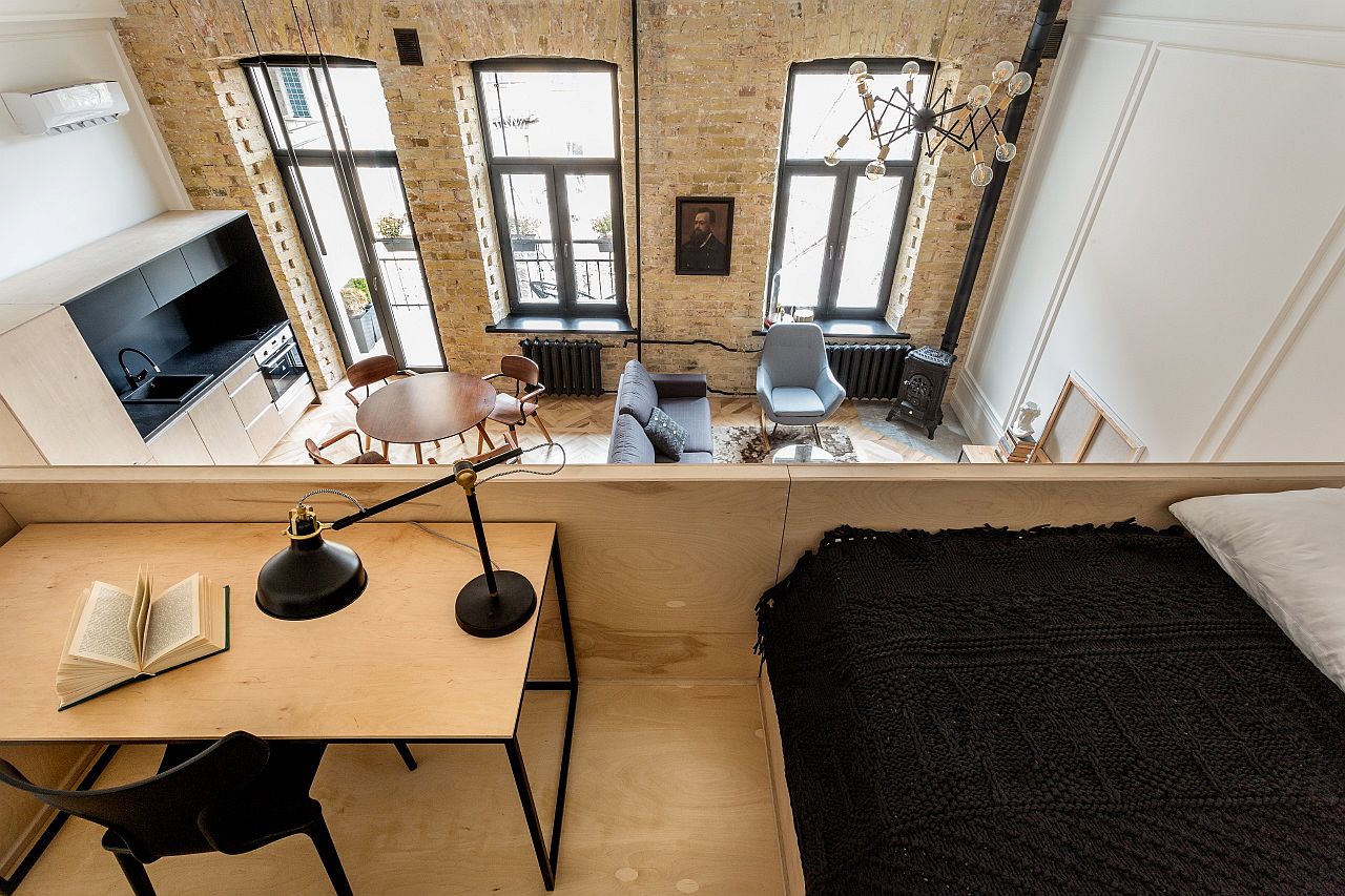 View of the living area from the loft level bedroom above that also has a workspace