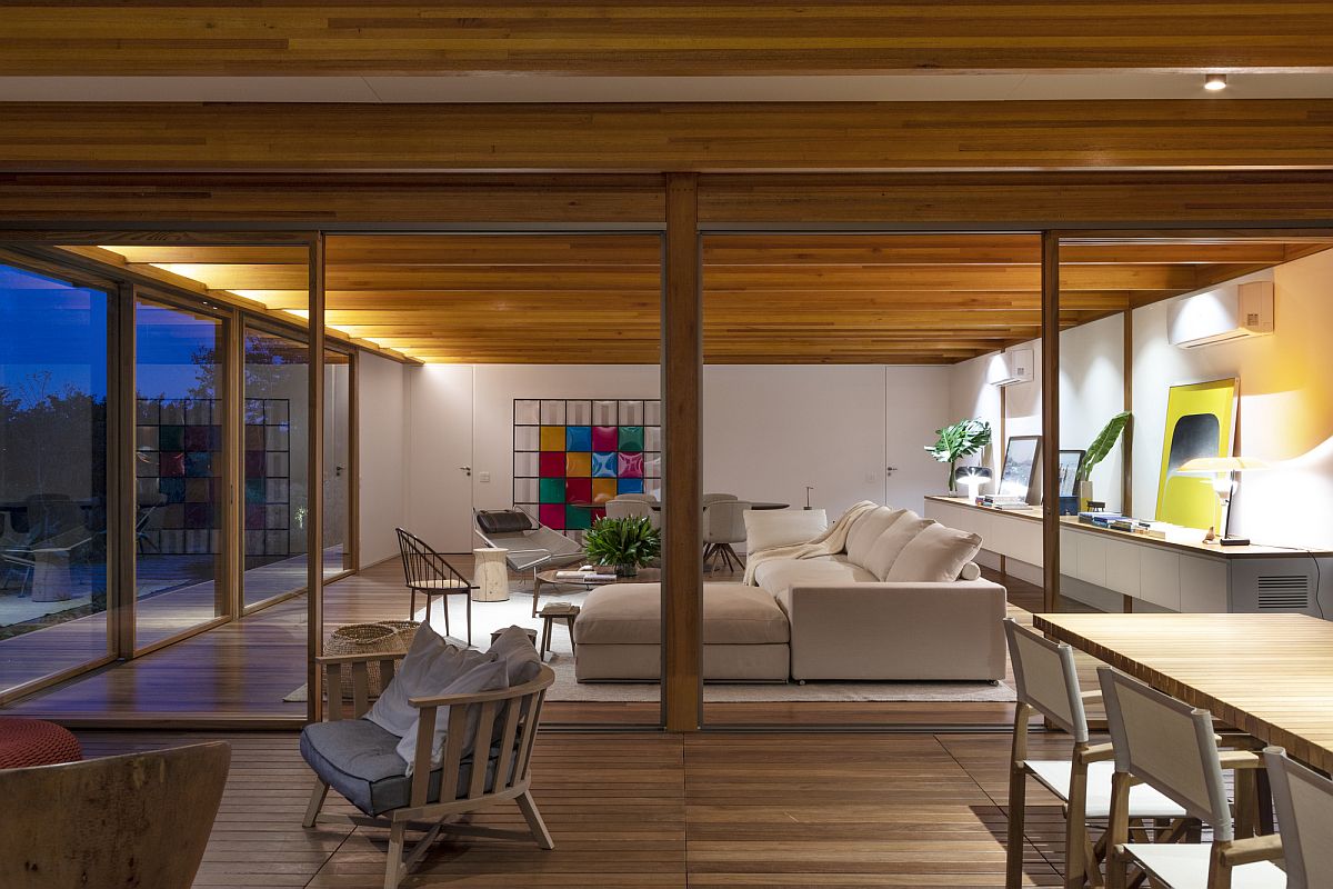 Warm lighting adds to the cozy appeal of wood inside the open living area