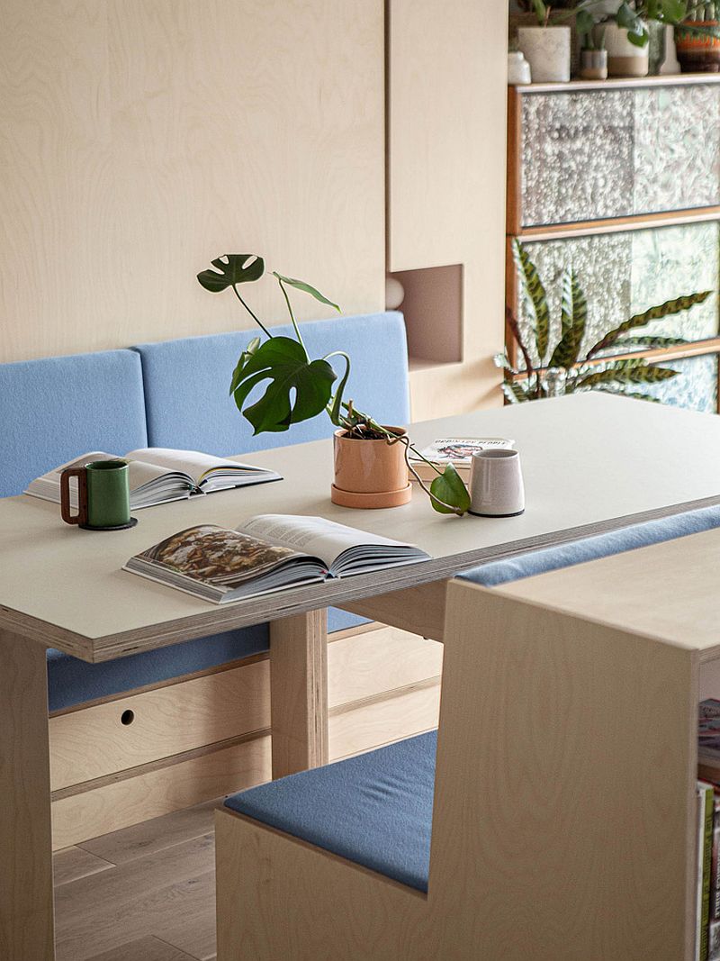 Wood and blue bench and seating becomes the heart of the new apartment interior