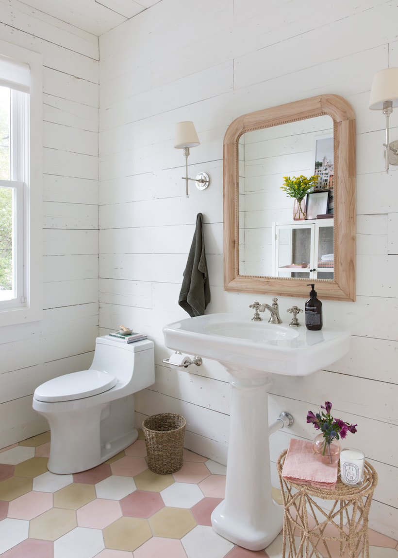 Wooden bathroom mirror in a bathroom with white shiplap