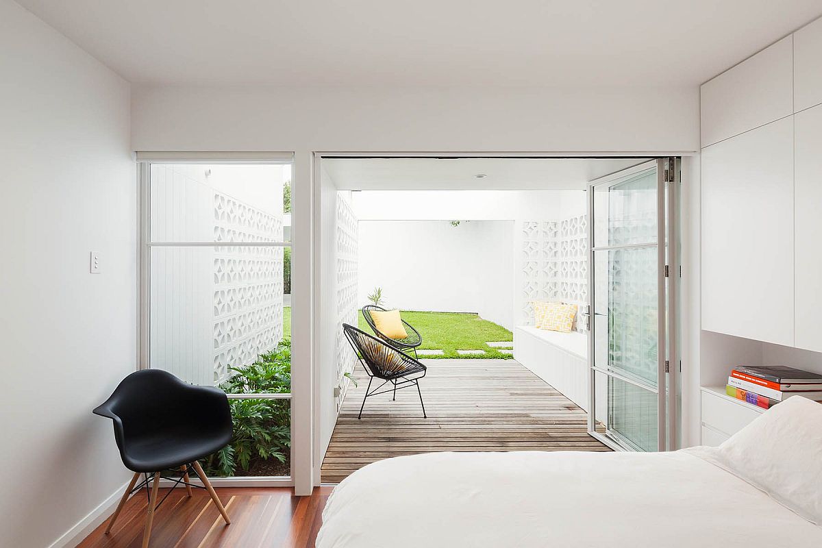 Wooden deck extends from the bedroom and into the garden outside