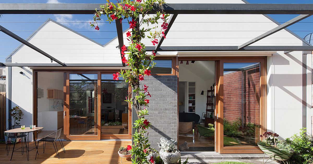 Wooden deck extends the living area outside even as the sliding doors connect the interior with the outdoors