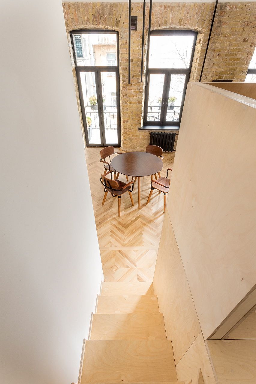 Wooden staircase leading to the loft level also offers storage area