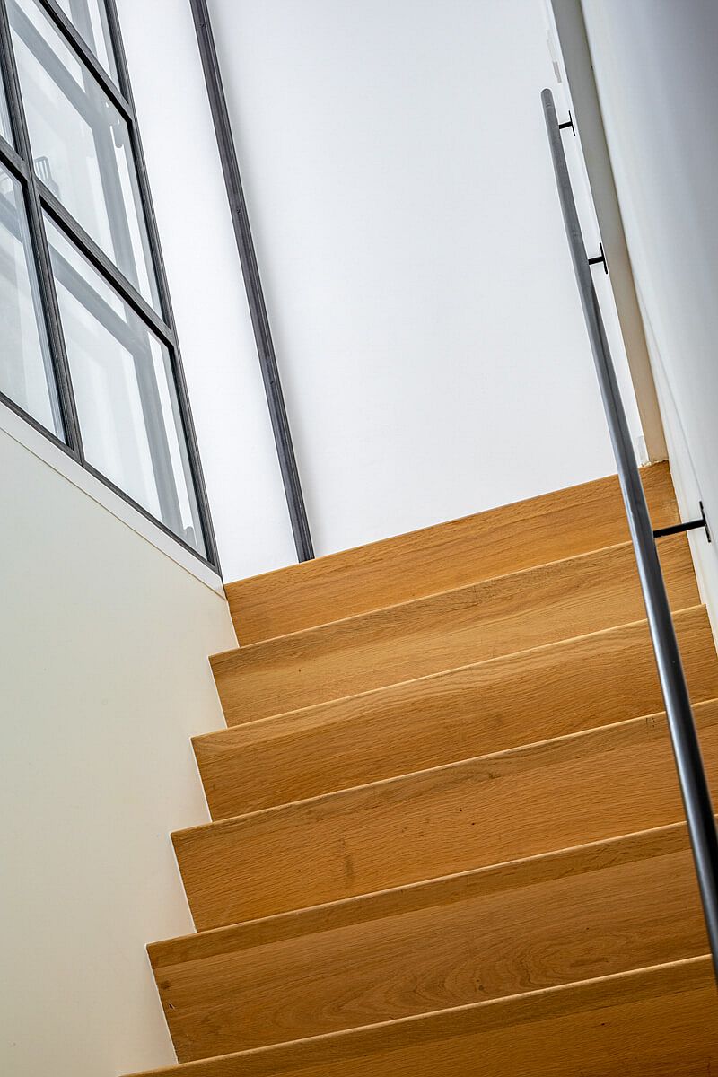 Wooden staircase leading to the top level of the house